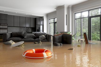Flooded modern living room with brown water, sofa, and orange life ring