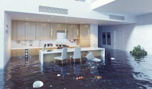 Flooded modern kitchen and dining area with water covering the floor up to the cabinets.