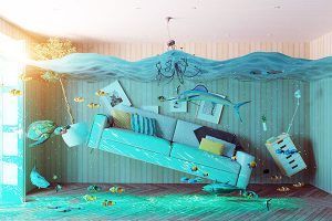 Upside-down turquoise living room with a couch, floating fish, and water spilling from the ceiling