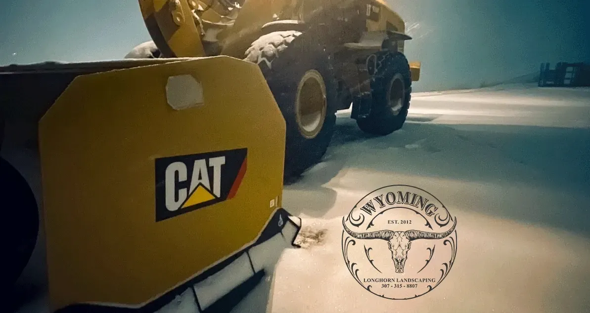 Yellow CAT construction vehicle on a sunlit road with a stamped emblem overlay