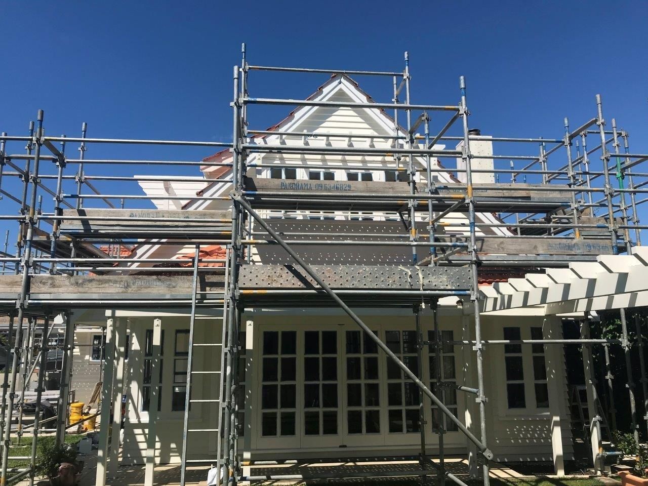 House under renovation with scaffolding in front of the facade