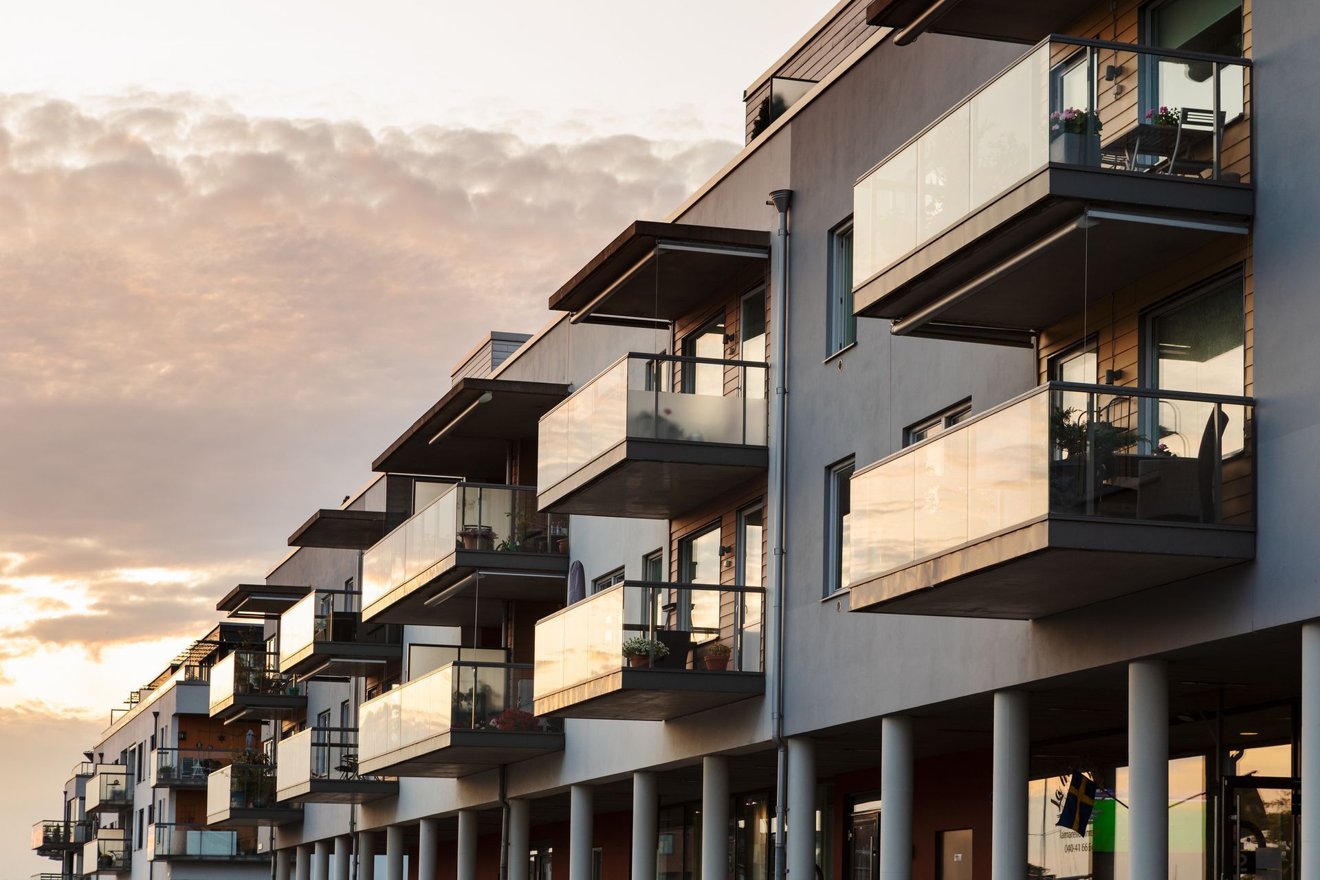 A row of apartment buildings with balconies on a cloudy day