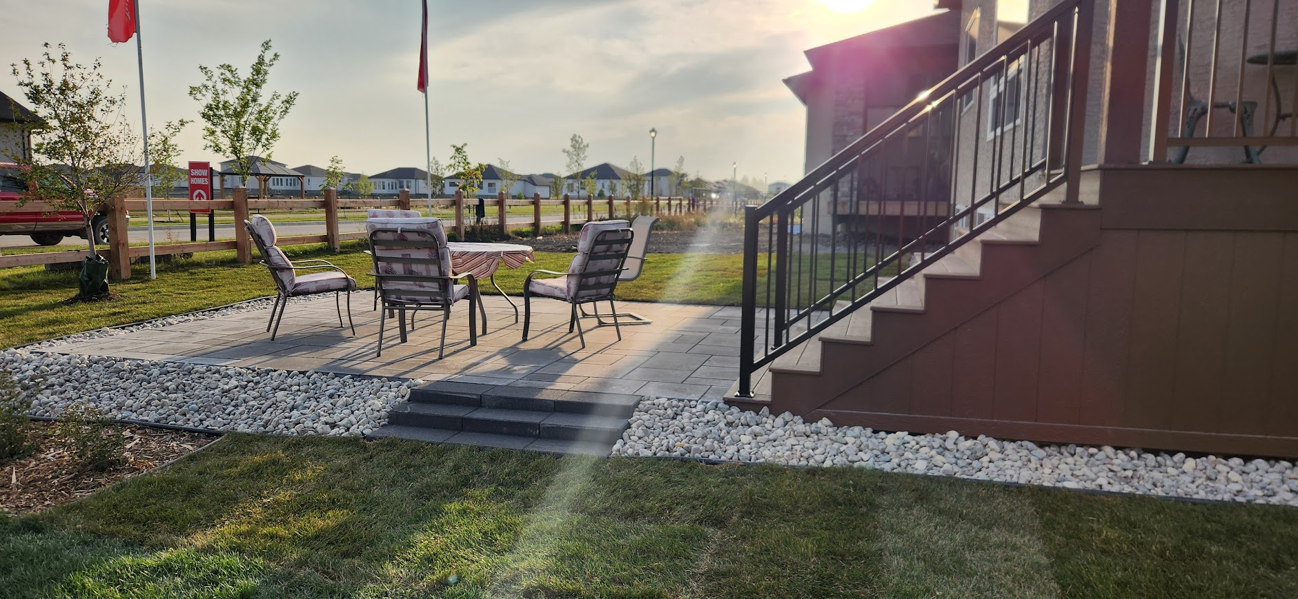 Backyard patio with seating and steps to deck