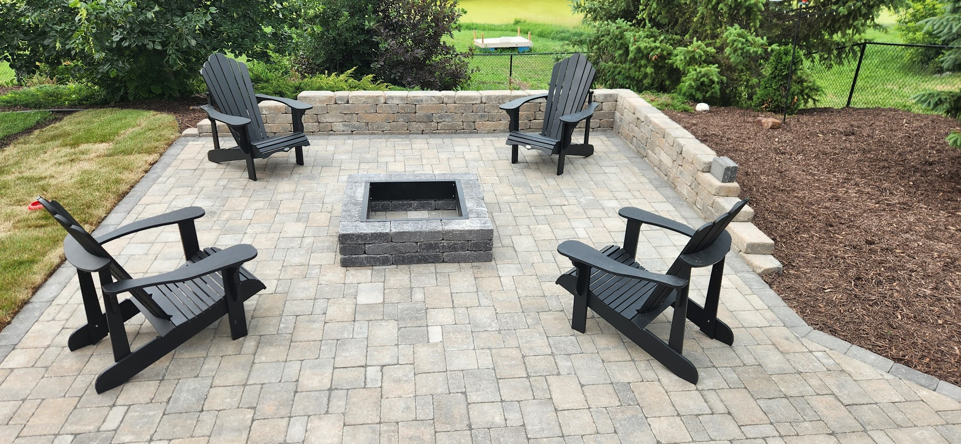 Stone patio with firepit and seating