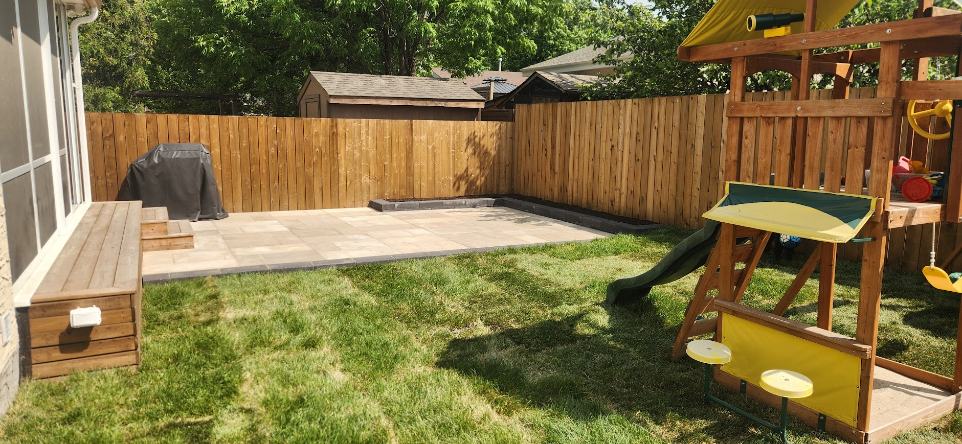 Playstructure with green lawn and patio