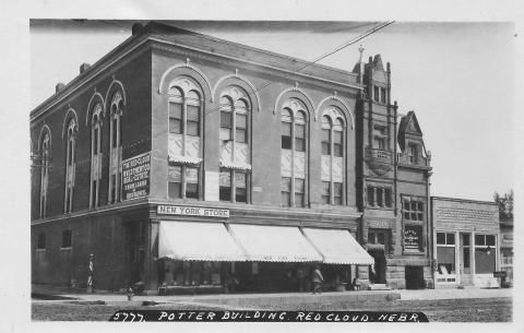 Potter Building, Red Cloud, Nebraska, a three-story brick building with arched windows and awnings.