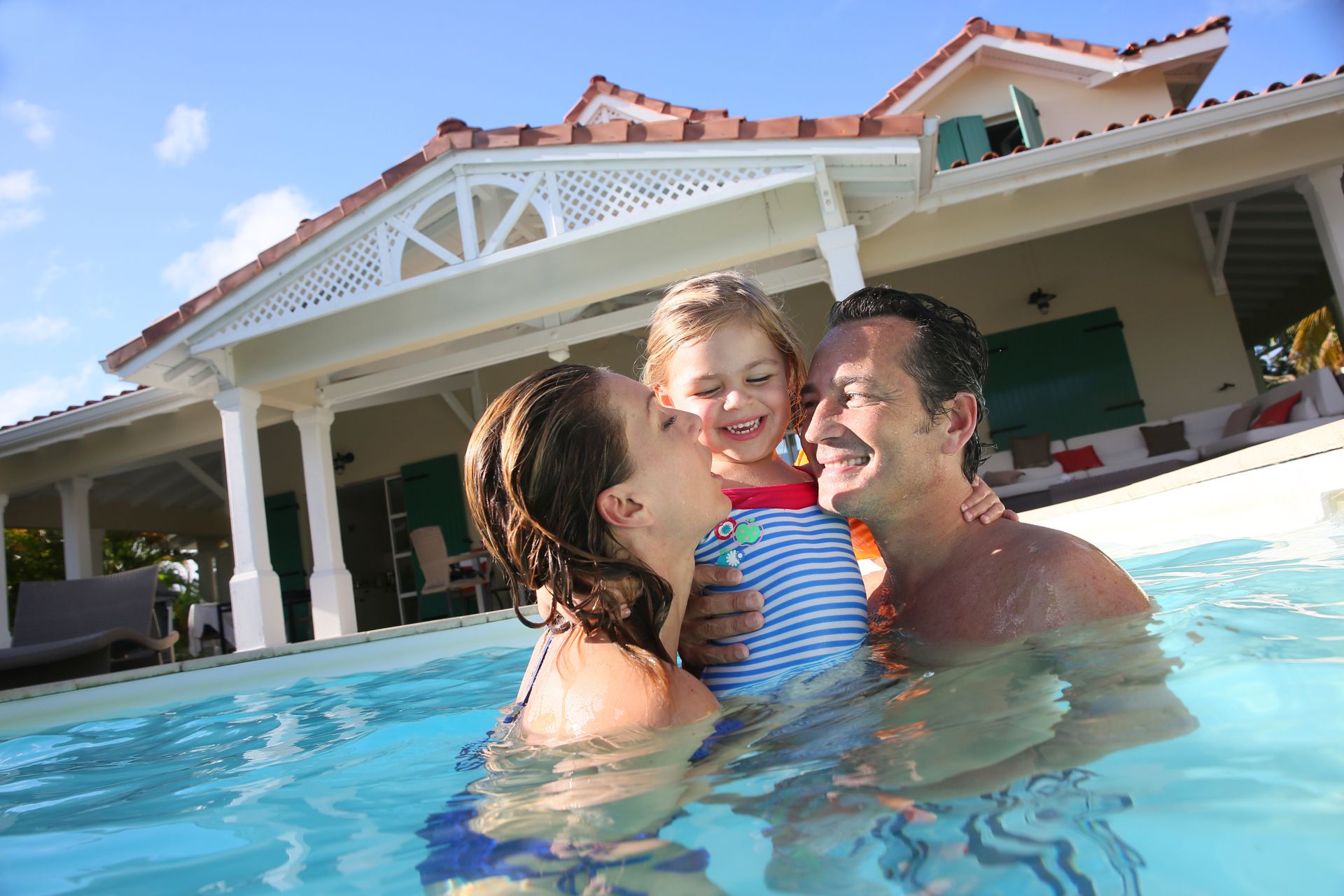 Happy Family Swimming on the Pool