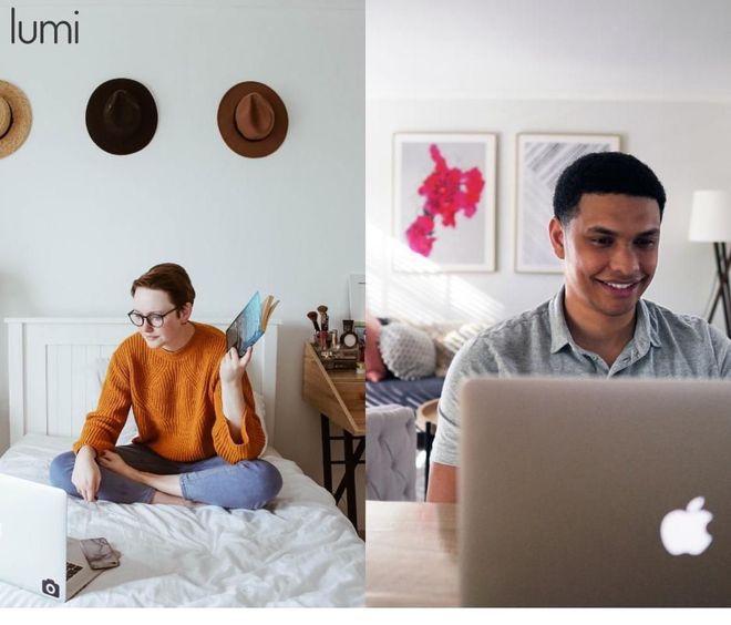 A woman sits on a bed next to a man using an apple laptop