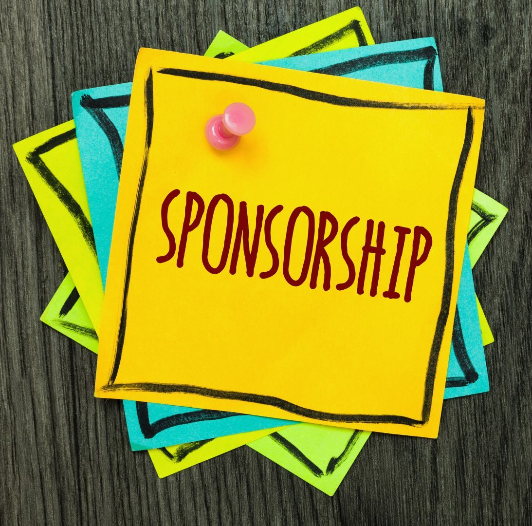 Yellow sticky note with “SPONSORSHIP” pinned over colorful layered notes on a wood background
