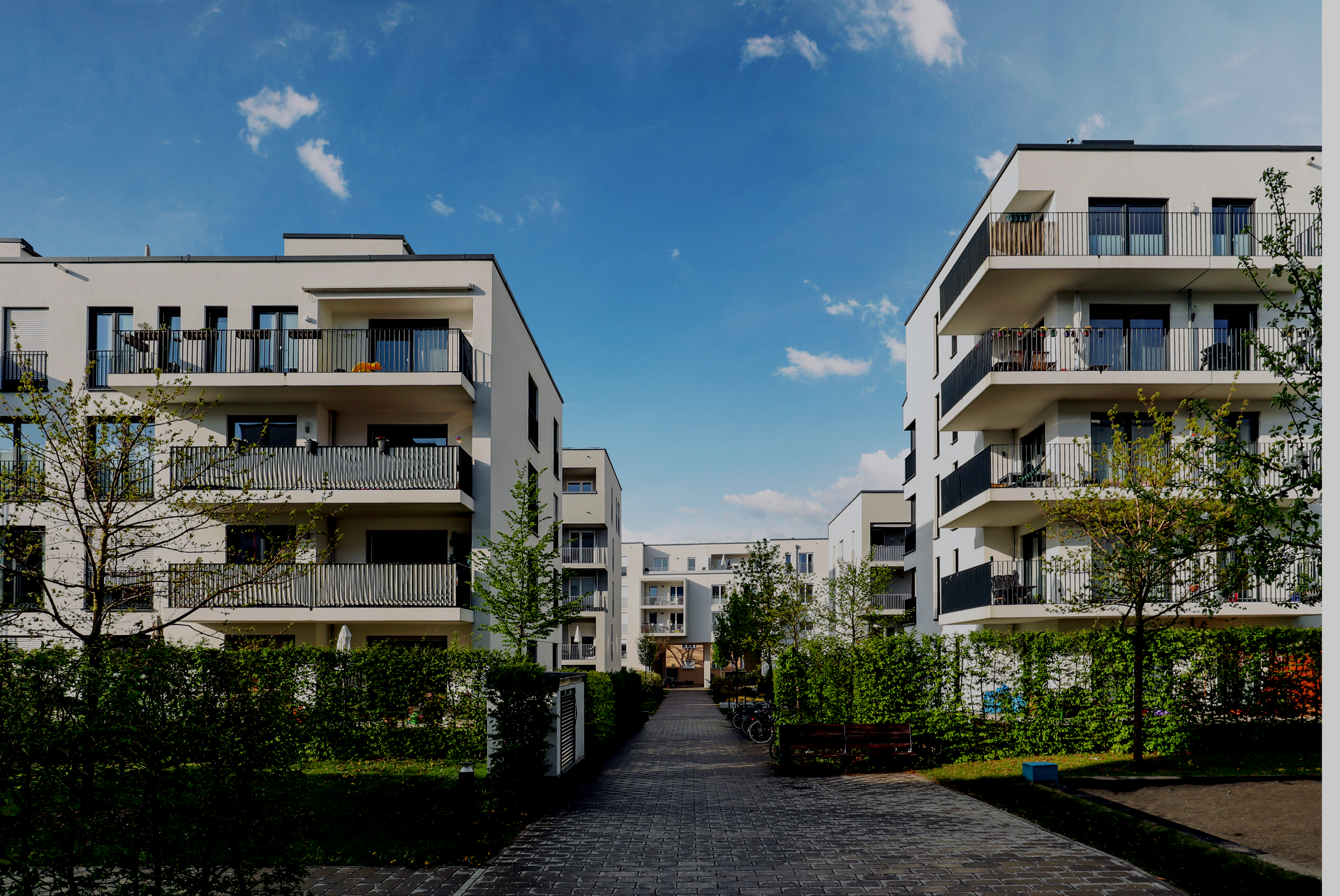 A row of apartment buildings with balconies on a sunny day
