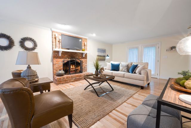 a living room and kitchen with a light color pallet