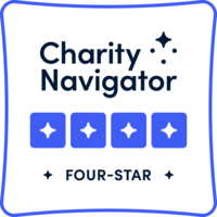 Charity Navigator Four-Star rating badge. Blue and white design with four stars and text.