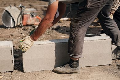Masonry contractor services installing concrete blocks for durable wall construction project. Masonry contractor services installing concrete blocks for durable wall construction project.