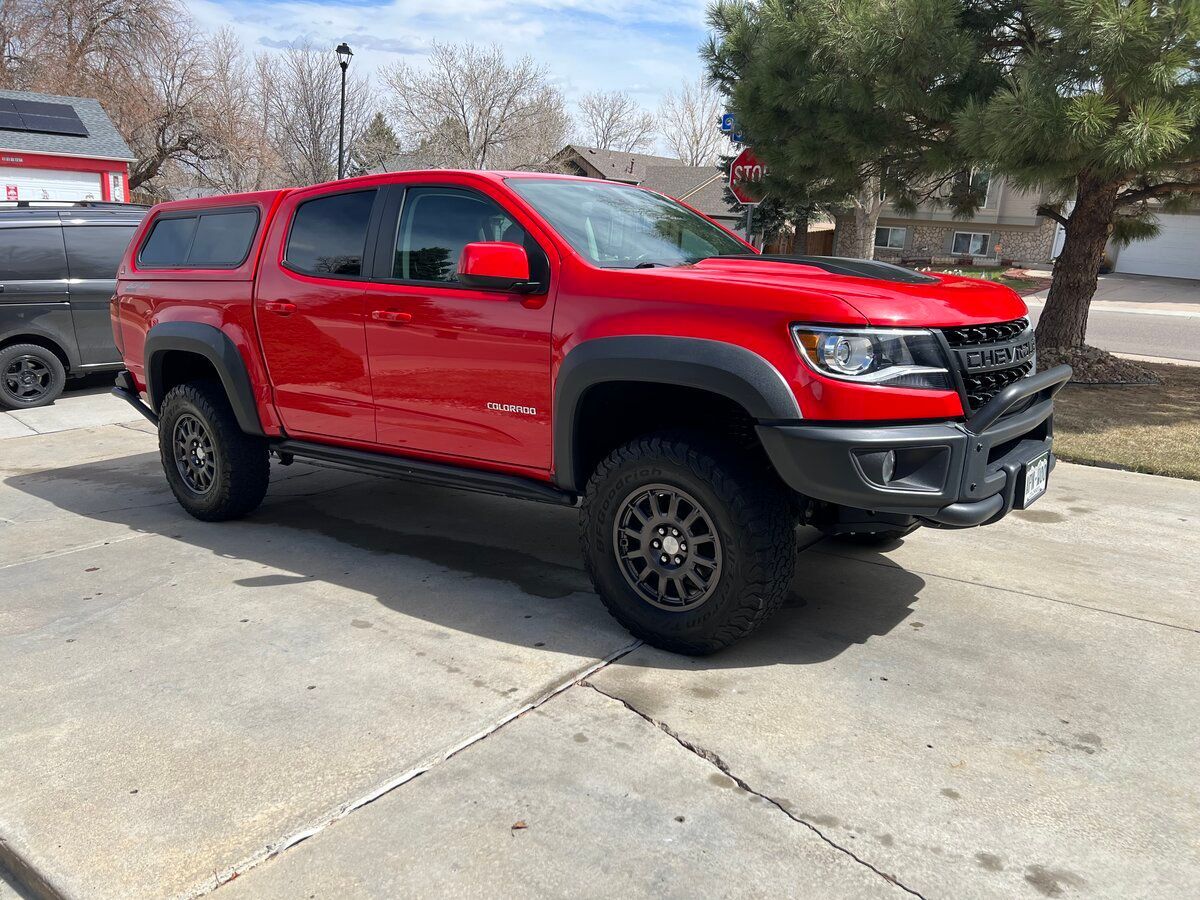 A red truck is parked on the side of the road.