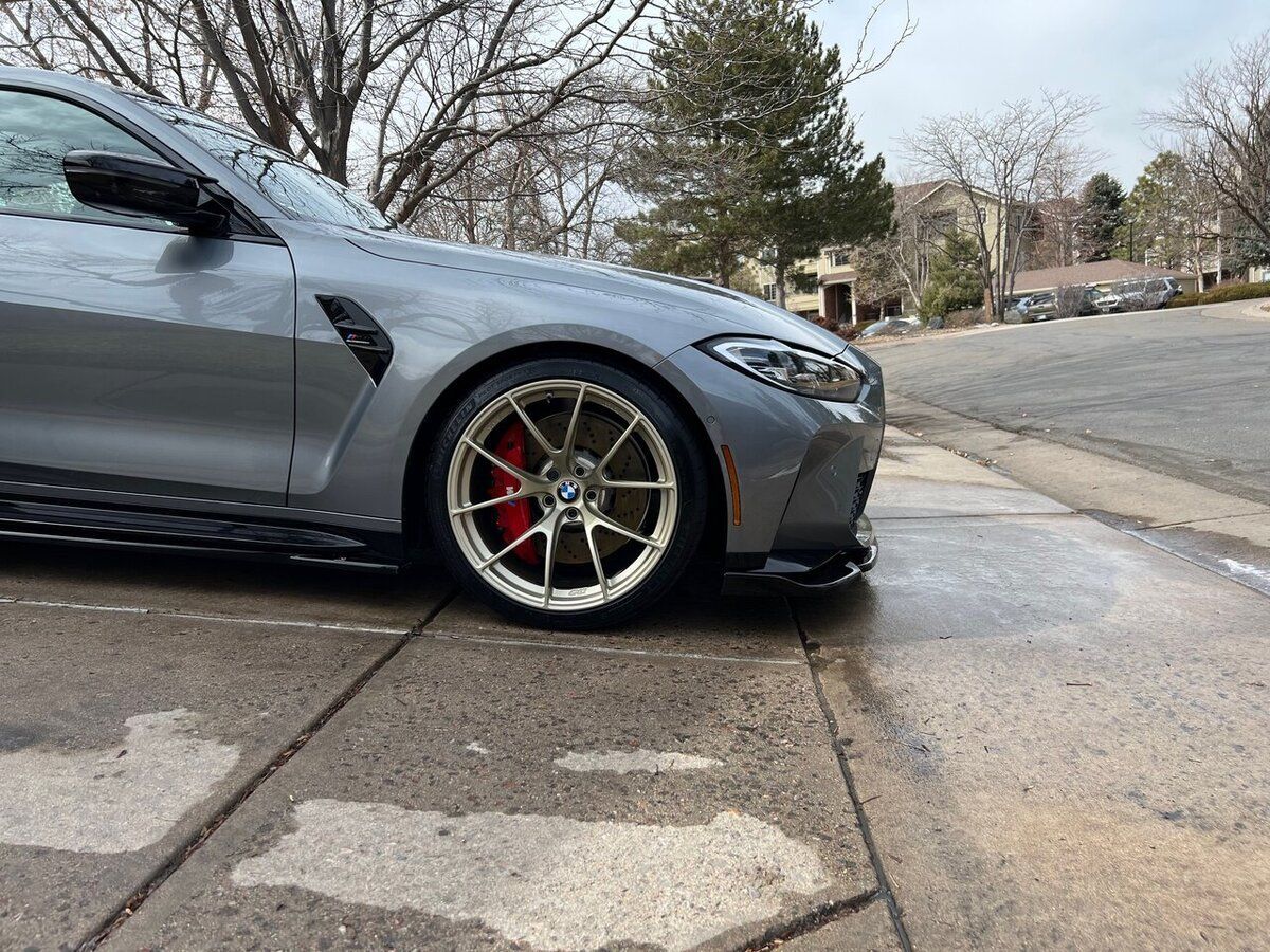 A bmw m4 is parked on the side of the road.