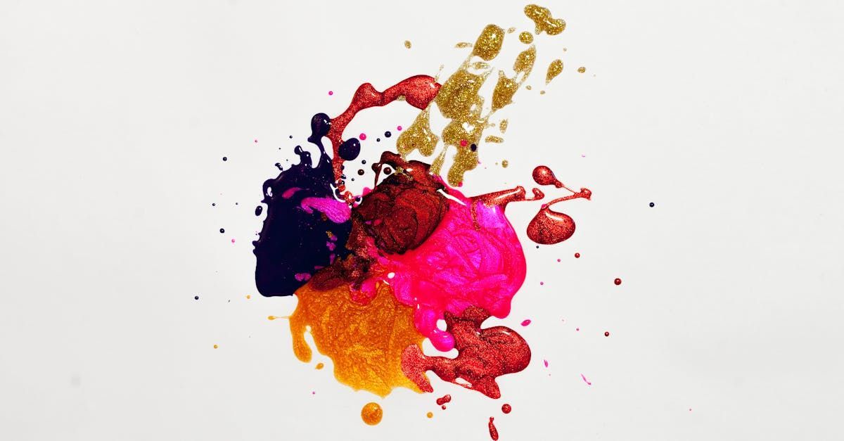 Colorful paint splatters on a white background: gold, orange, red, pink, purple, and dark blue.