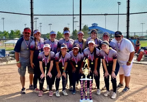 Explosive Fastpitch softball team posing with trophy