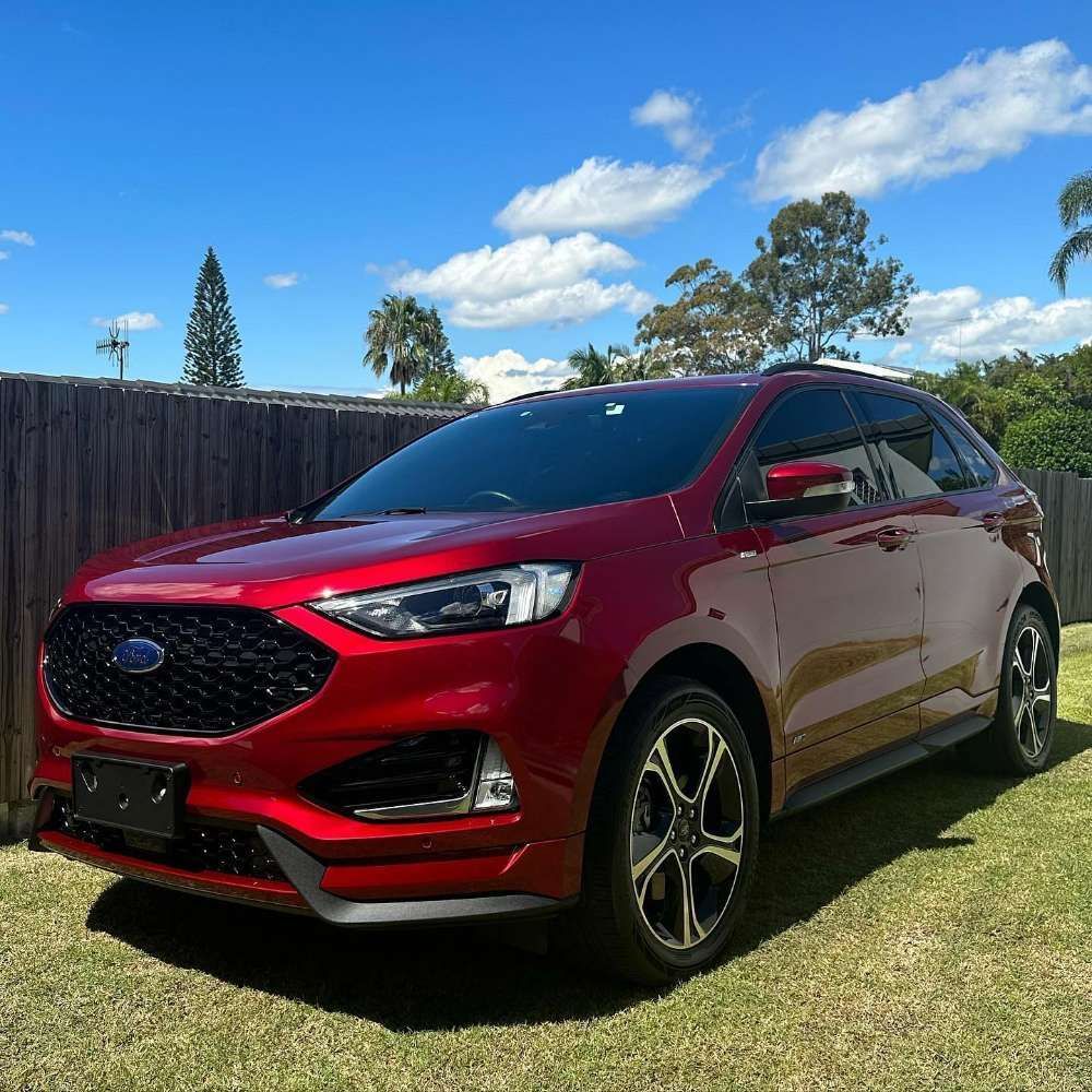 Red Ford Edge SUV Parked on Grass — Remedy Mobile Car Detailing in Gold Coast, QLD