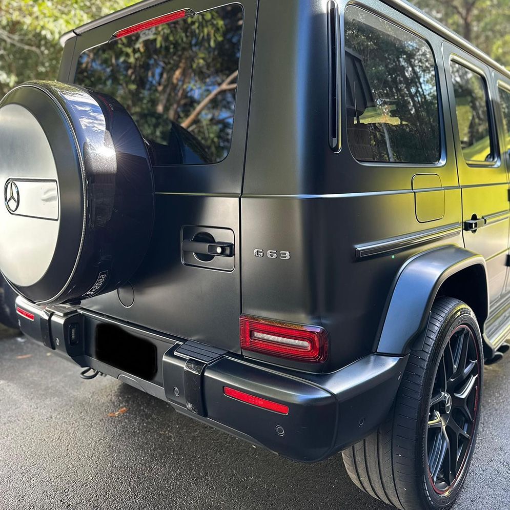 A Black Mercedes Benz G63 Is Parked On The Side Of The Road — Remedy Mobile Car Detailing in Mermaid, QLD
