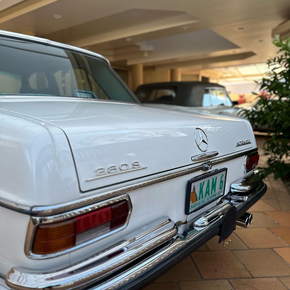 White Mercedes-Benz 280E Sedan, Parked Near a Building — Remedy Mobile Car Detailing in Burleigh, QLD