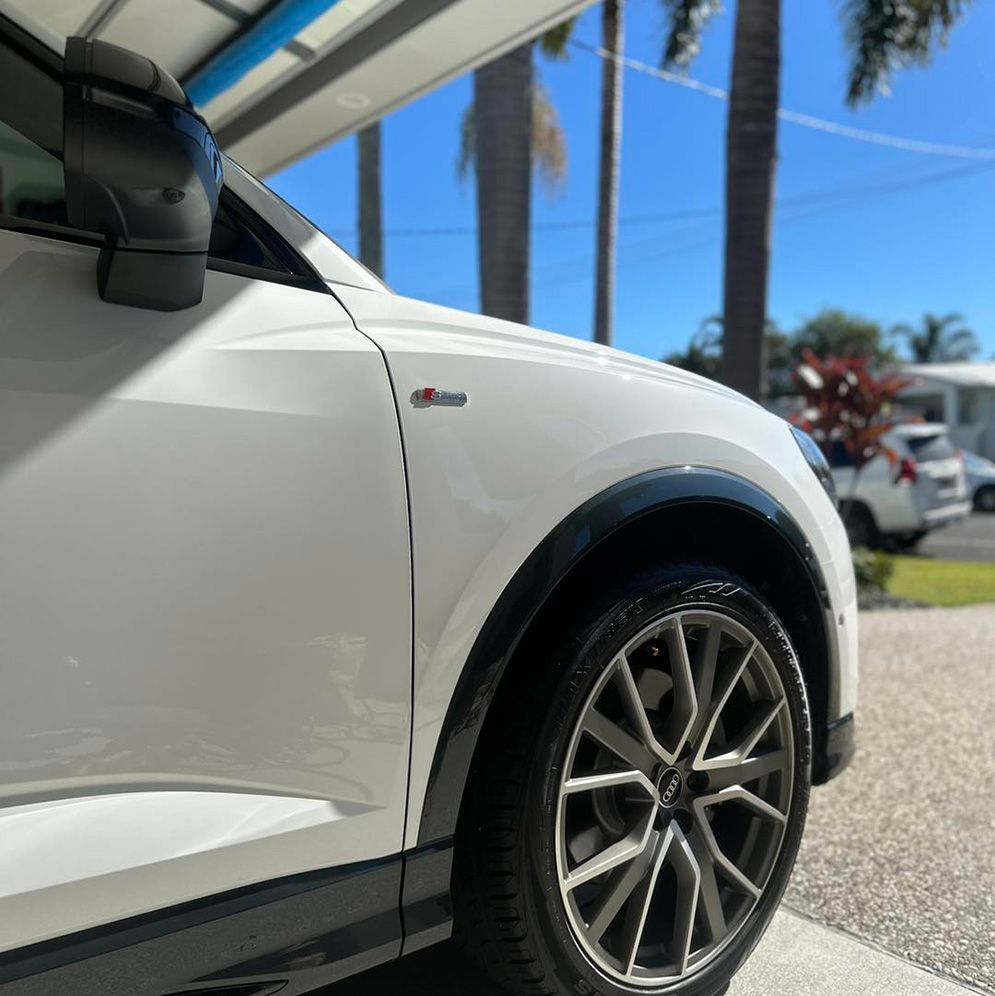 A White Car Is Parked On The Side Of The Road — Remedy Mobile Car Detailing in Palm Beach, QLD