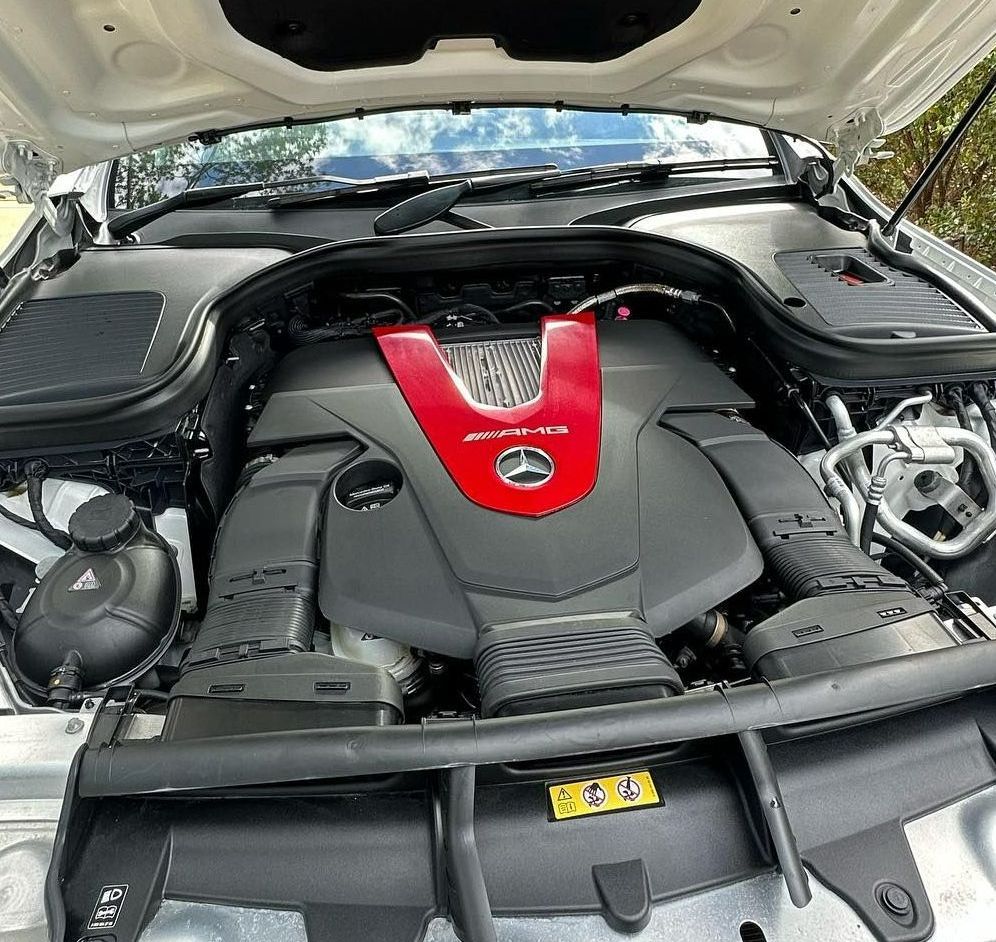 A Close-up Of A Car Engine Bay, Showing A Black Engine — Remedy Mobile Car Detailing in Currumbin, QLD