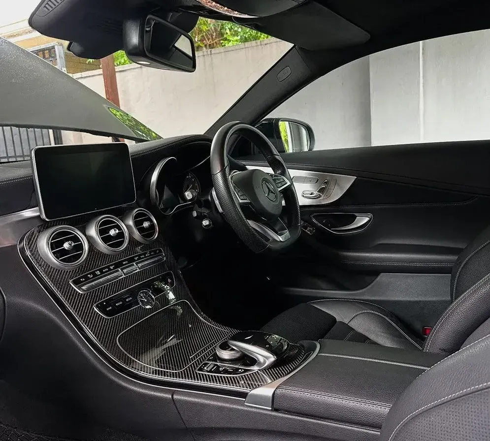 The Interior Of A Black Car With A Tablet On The Dashboard — Remedy Mobile Car Detailing in Palm Beach, QLD