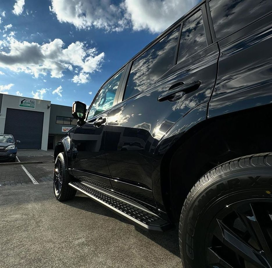 A Black Suv Is Parked In A Parking Lot In Front Of A Building — Remedy Mobile Car Detailing in Kingscliff, NSW