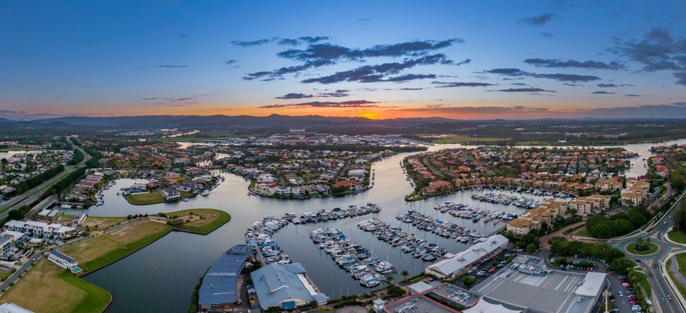 An Aerial View Of A Marina With Boats Docked At Sunset — Remedy Mobile Car Detailing in Hope Island, QLD