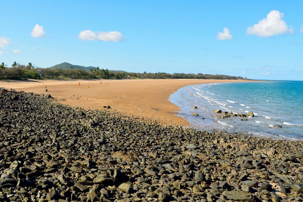 A Rocky Beach With A Large Body Of Water — Remedy Mobile Car Detailing in Palm Beach, QLD