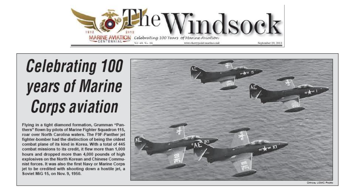 Marines aircraft in formation above water, celebrating 100 years of Marine Corps aviation. Newspaper heading