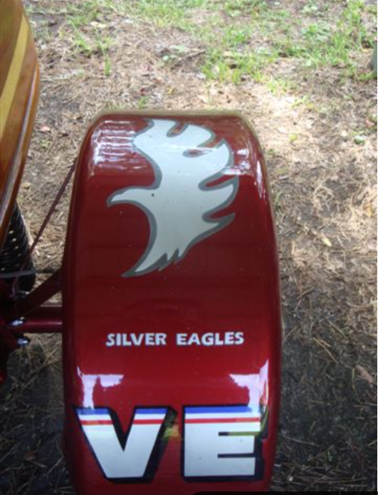 Red vehicle part with silver eagle logo and