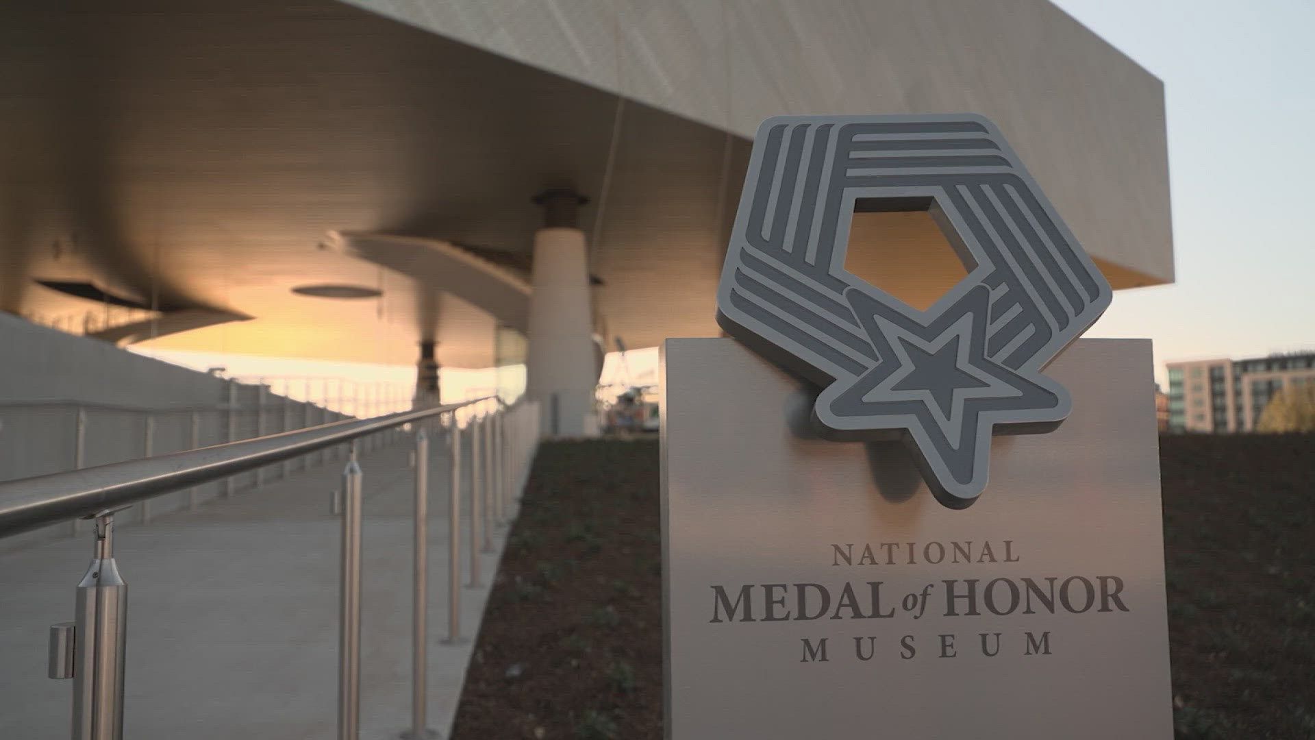 National Medal of Honor Museum sign with the building in the background. Sunset lighting.