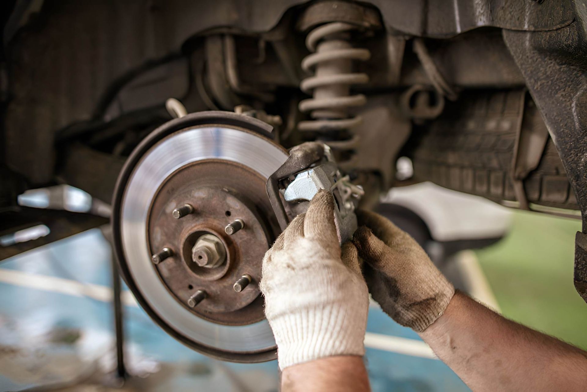 A Person is Fixing a Brake Pad on a Car — ANI Automotive in Long Jetty, NSW