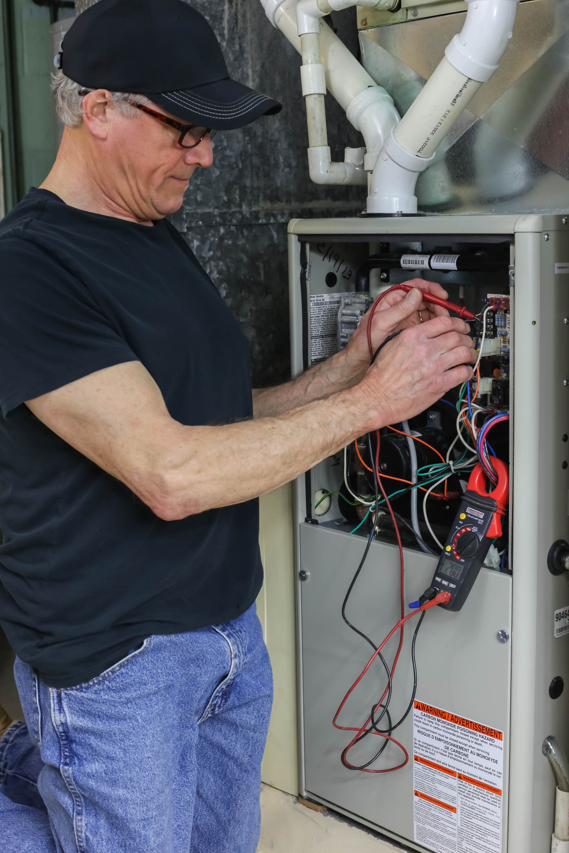 A man is repairing a furnace.