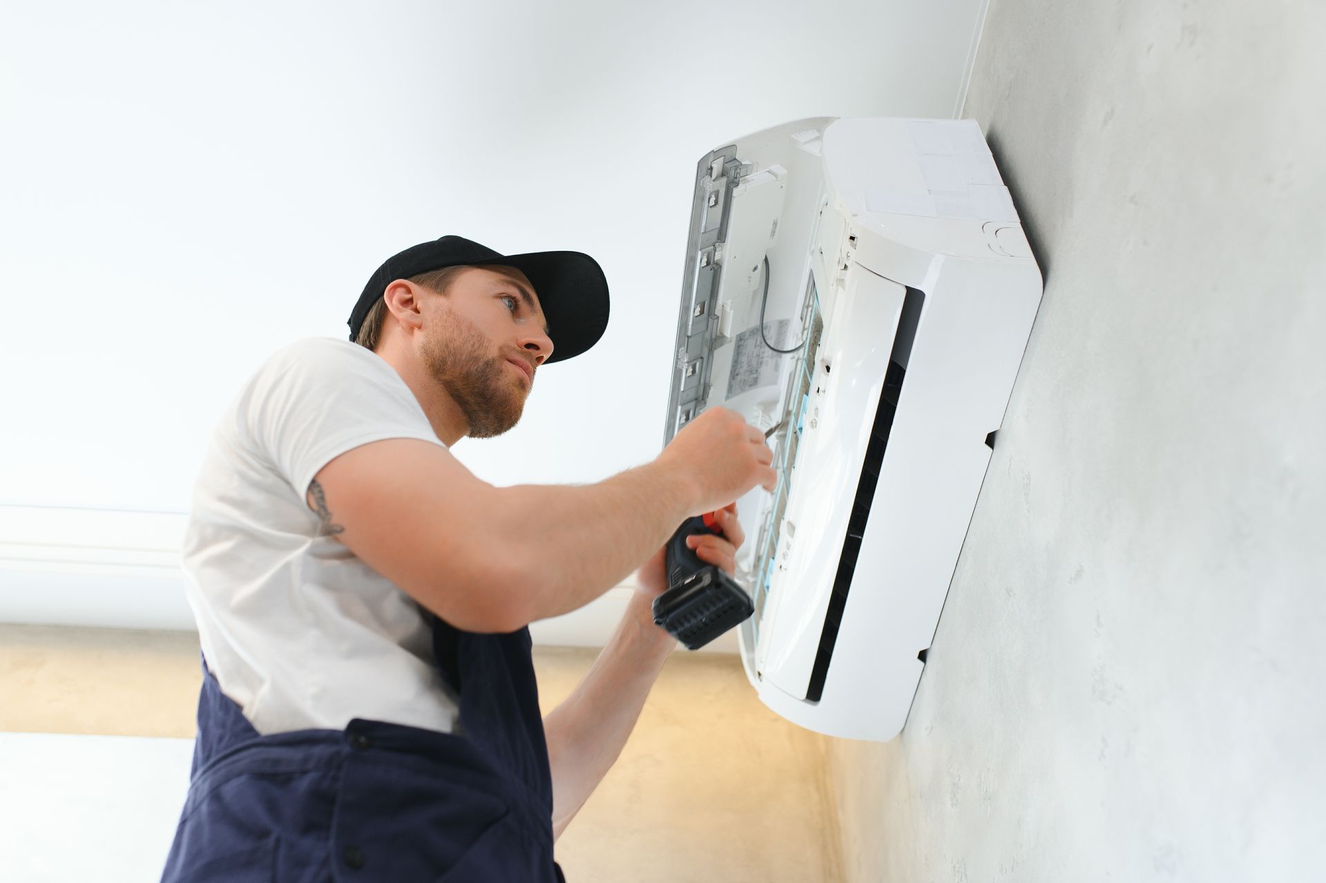 A technician performs AC repair on a unit.