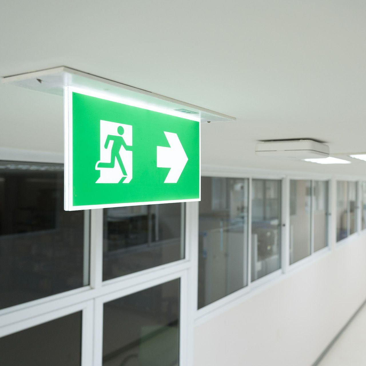A green exit sign with an arrow pointing to the right