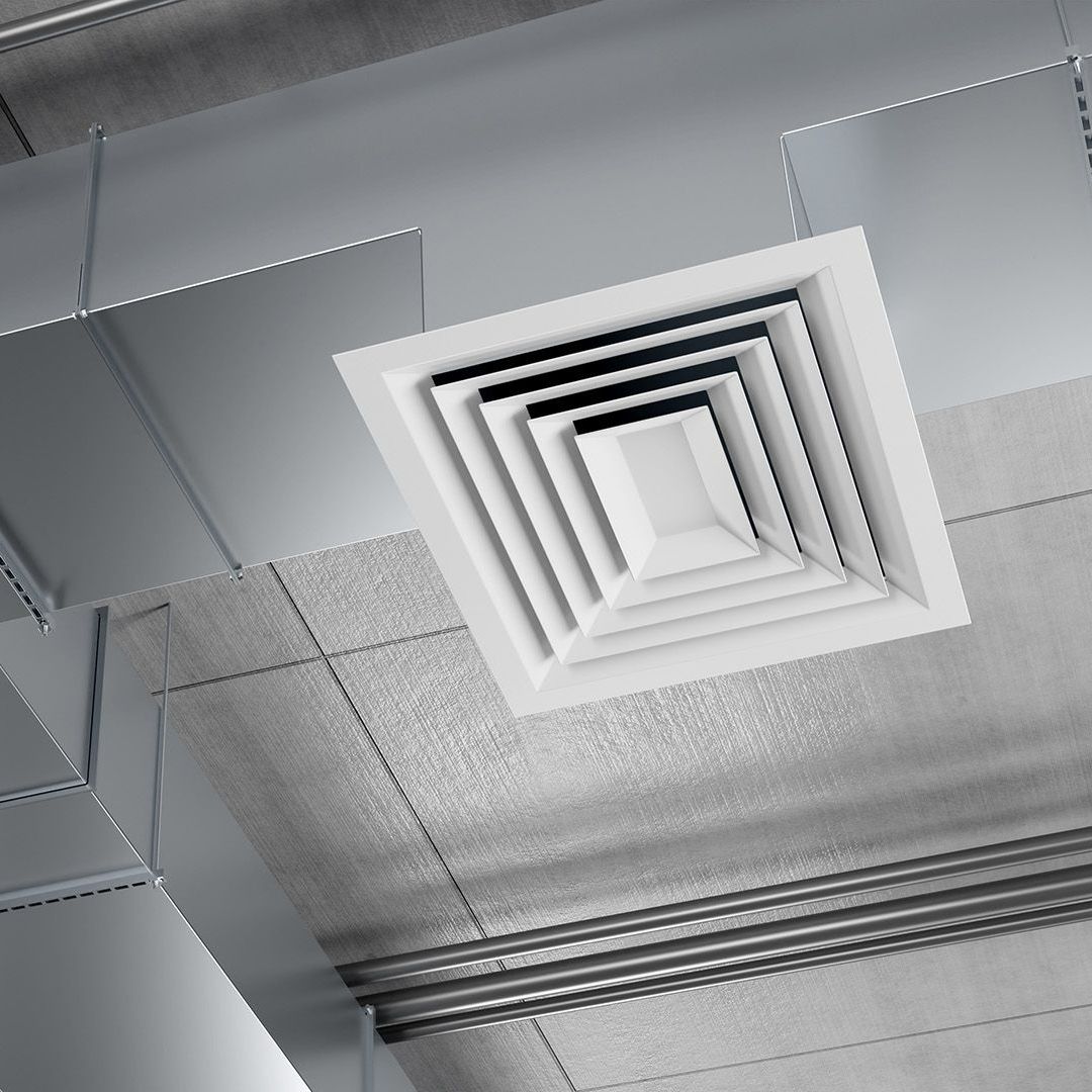 A square air vent is hanging from the ceiling of a building.