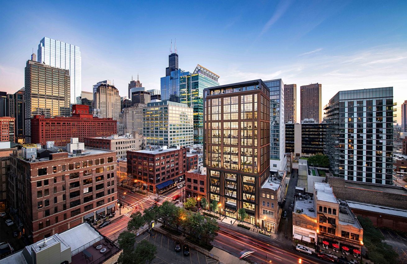 An aerial view of a city skyline with a large building in the middle.