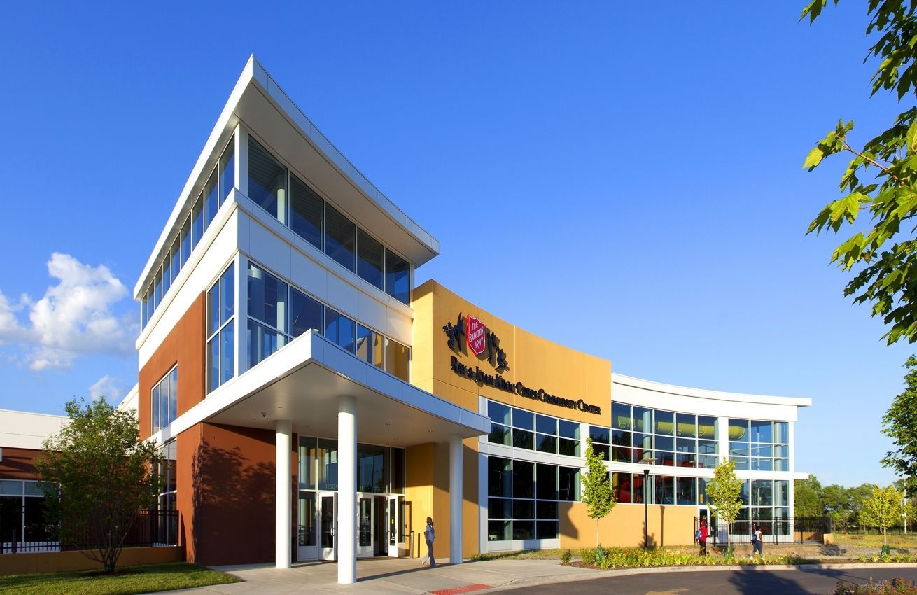 A large building with a lot of windows and trees in front of it