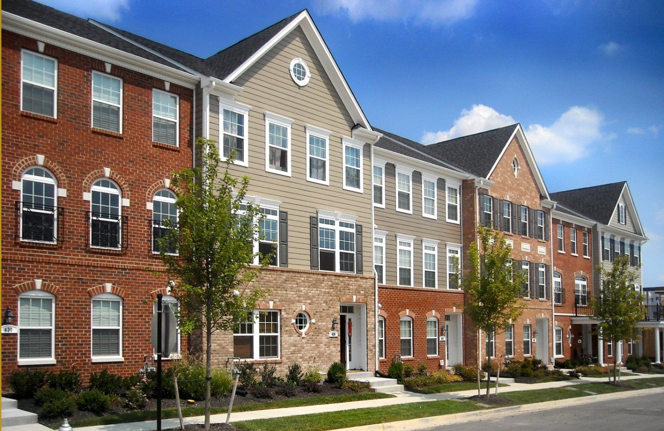 A row of brick buildings with a lot of windows