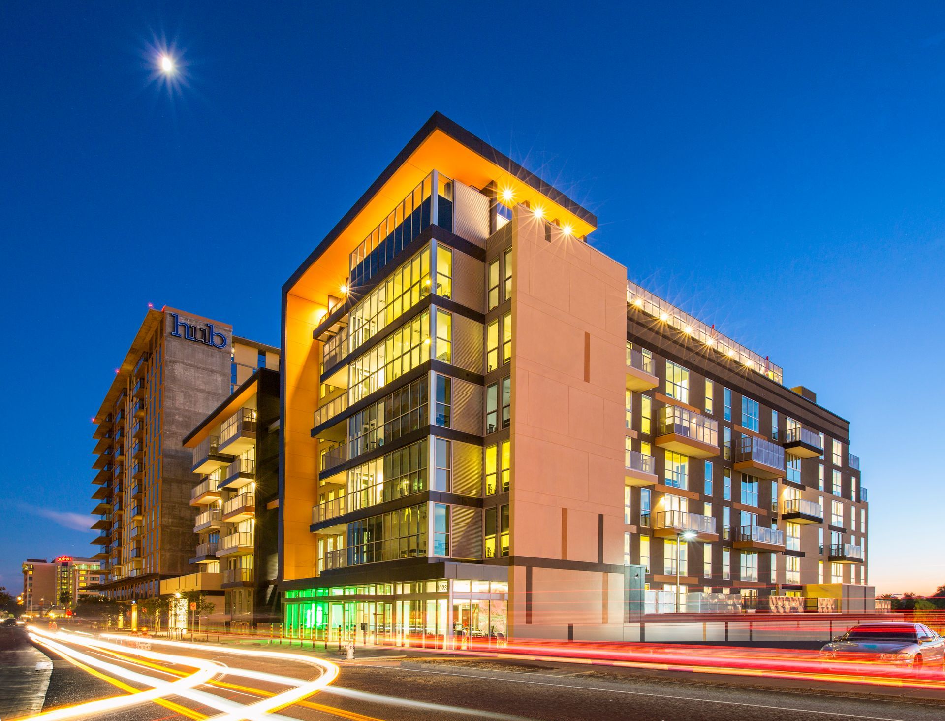 A large building with a lot of windows is lit up at night.