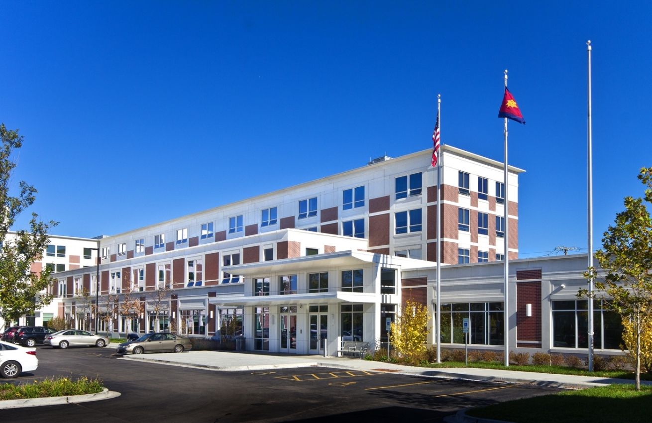 A large building with a flag in front of it