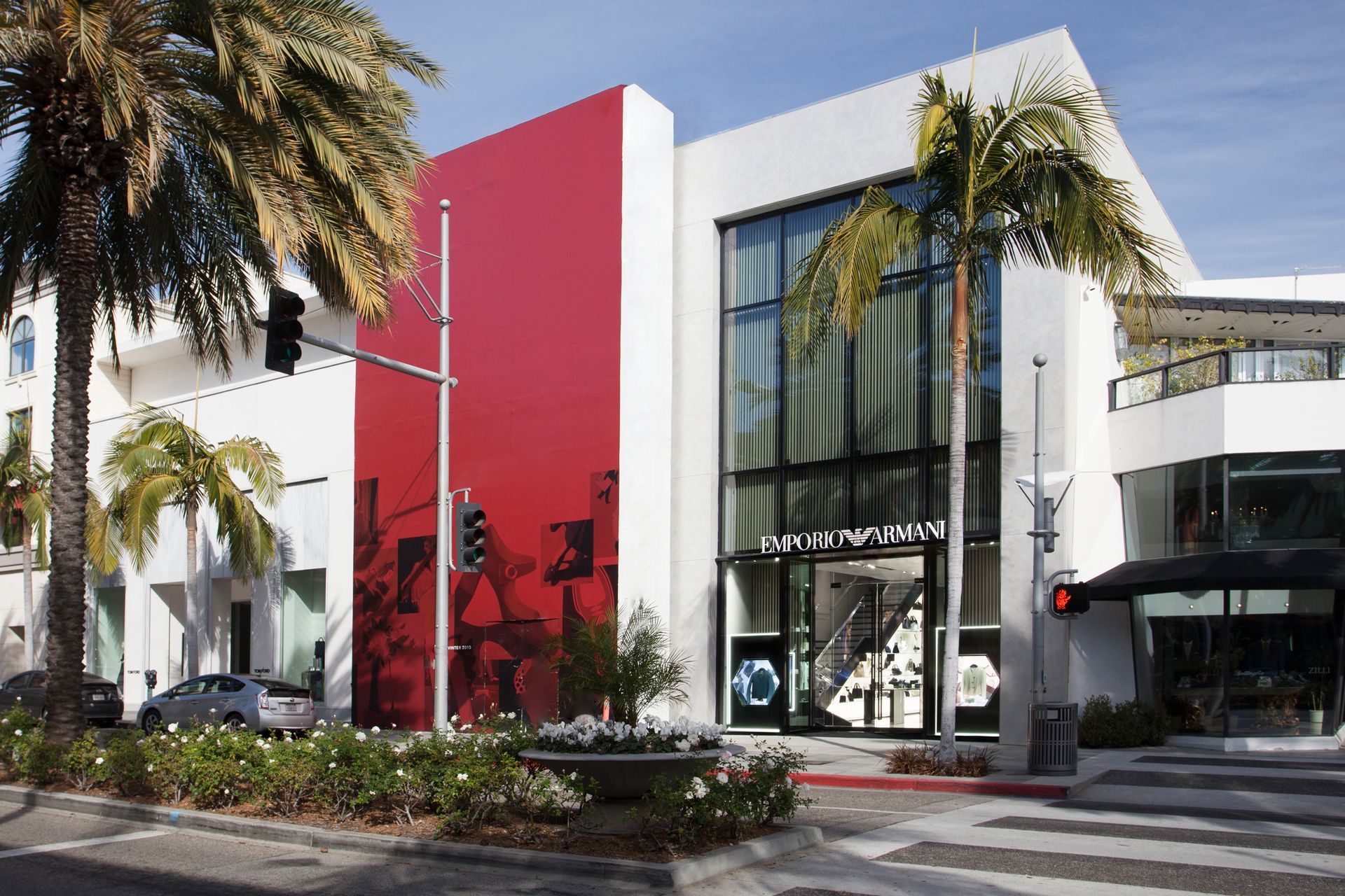 A red and white building with a palm tree in front of it