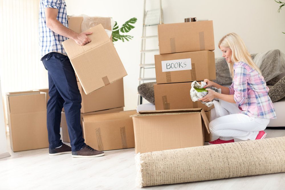 A Man And A Woman Are Moving Into A New Home — Removalists In Ballina