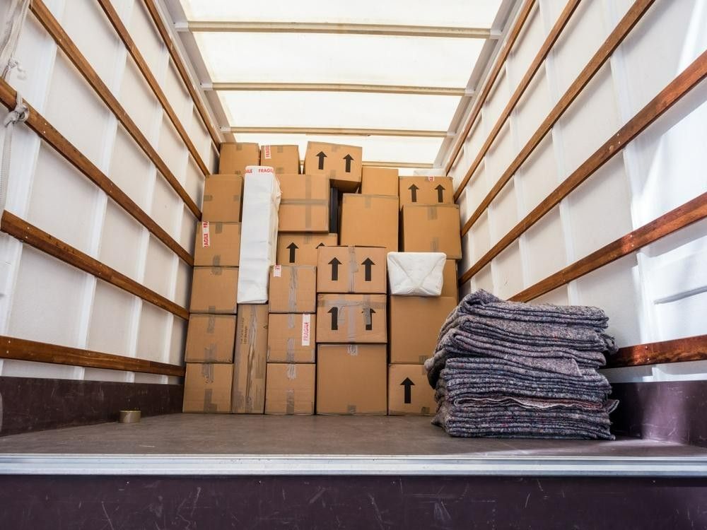 Loading Boxes Into a White Truck For Efficient Transport — Professional Removalists In Alstonville