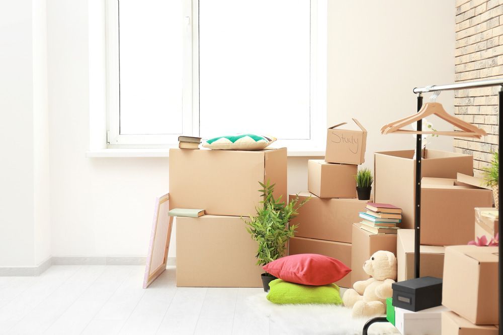 A Room Filled With Lots Of Cardboard Boxes And A Teddy Bear — Removalist In Yamba