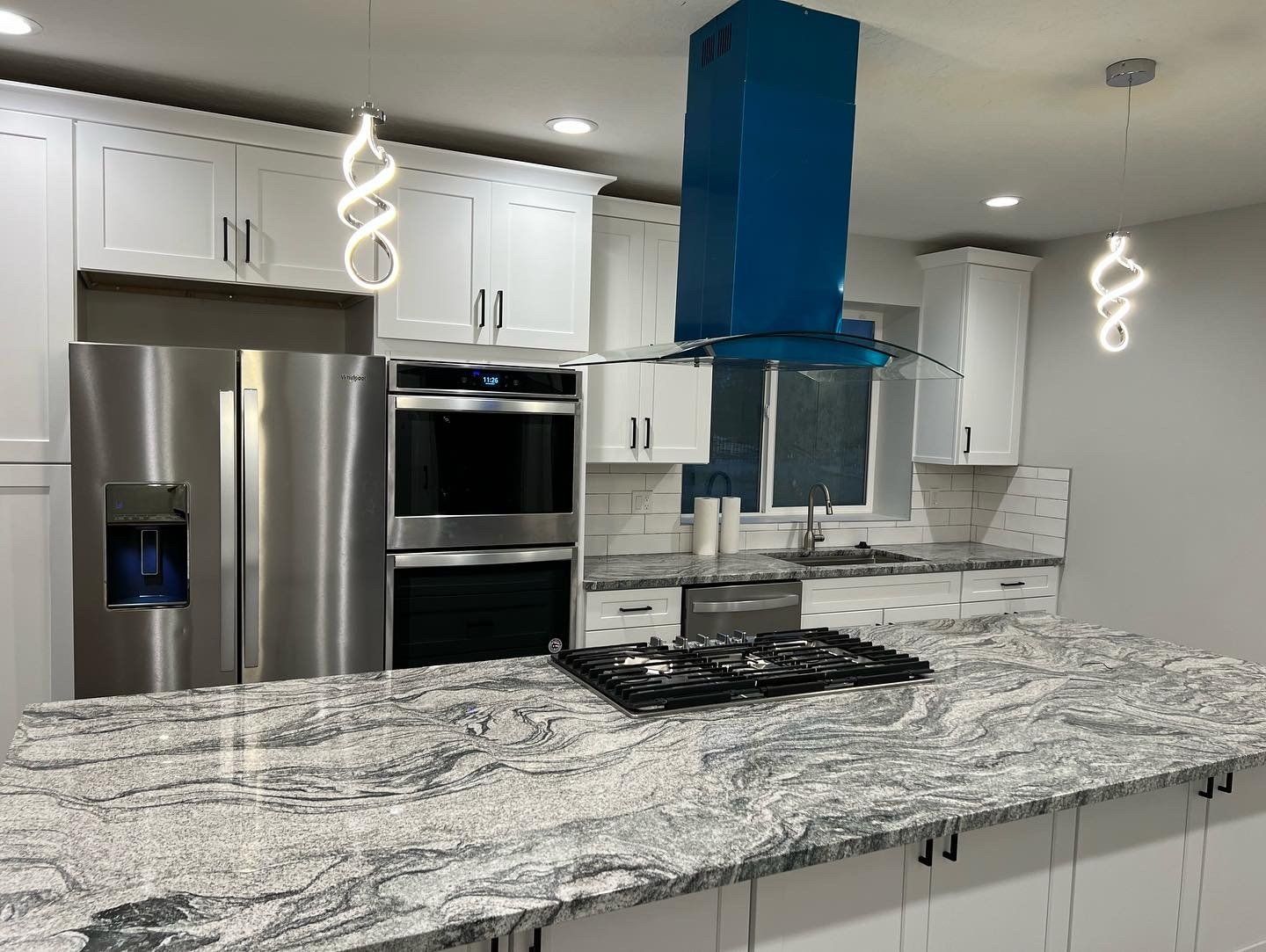 Kitchen with new cabinets, countertops, splash walls, lighting and appliances.