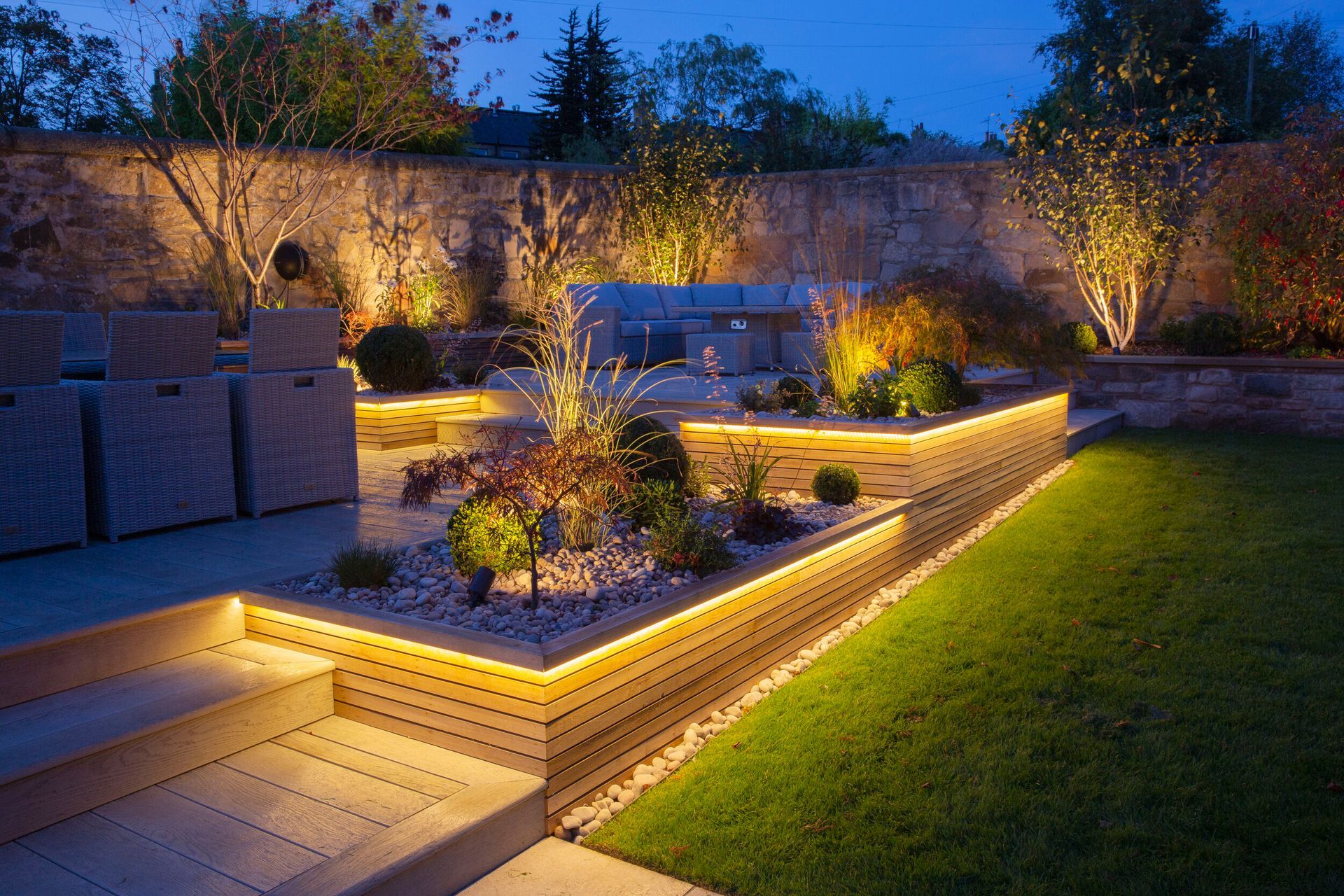 A garden with a lot of lights on it at night.