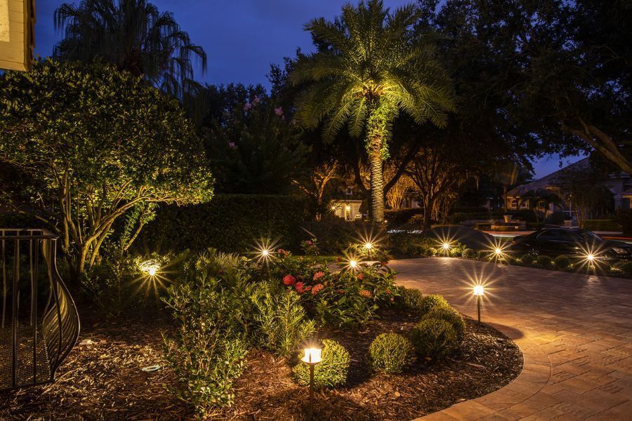 A driveway with lots of lights on it at night.